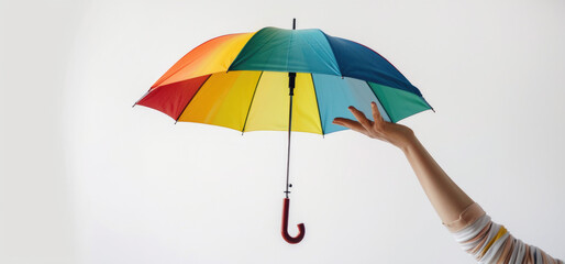 Person holding a multicolored umbrella, suitable for various concepts and designs