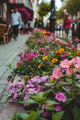 A row of flowers lining a sidewalk next to a lamp post. Perfect for urban and nature themes