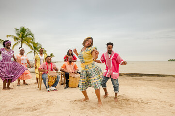 Young black couple dancing at a Caribbean beach party.