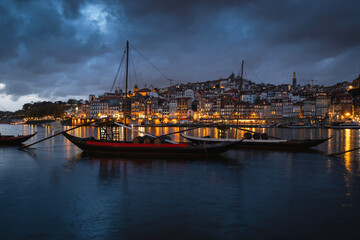 Porto, Portugal old town on the Douro River with traditional rabelo boats at night. With wine barrels from the port on the Douro River, Ribeira I in the background, Porto, Portugal. - 788576727