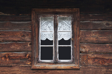 Wooden rustic window in cottage house. Lace curtains glass window home. Rusty architecture....
