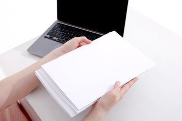 woman with a book, magazine and laptop on a white background. student. business. mockup