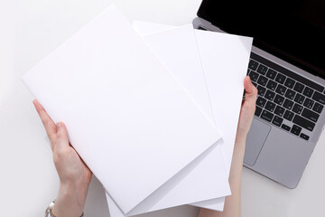 woman with a book, magazine and laptop on a white background. student. business. mockup