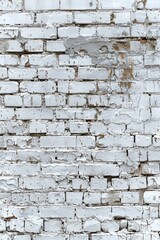 A white brick wall with peeling paint. Suitable for backgrounds and textures