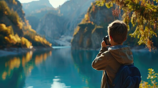 A person taking a picture of a lake. Suitable for travel and photography concepts