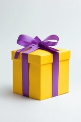 Obraz premium A yellow gift box with a purple ribbon, perfect for any occasion
