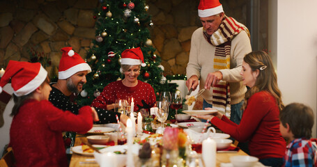 Christmas, dinner or family eating food in home on holiday together for bonding in social...