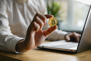 man holding bitcoin in hand. crypto buying and investment concept - 788613925