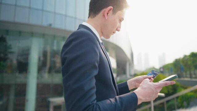 mixed raced business man using smartphone and credit card for online purchasing. Mobile network connection, online transactions, digital payment with credit card, online security, credit bureau