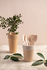 Eco friendly paper cup and green plant. Zero waste, plastic-free items. Stop plastic pollution. 
