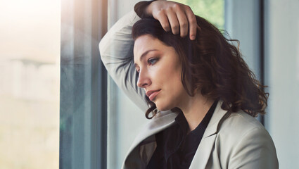 Business, window and sad woman with burnout or stress with kpi review mistake or depression....