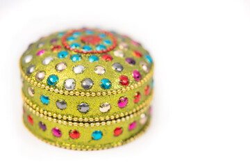 Macro photograph of small decorative round box yellow  green colors with glitter for jewelry and...