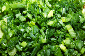Chopped chives, green background, full frame.