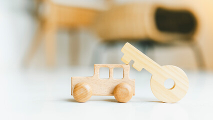 Wooden car and key model with sunlight, a symbol for buying a new car, vehicle car auto repair service maintenance.