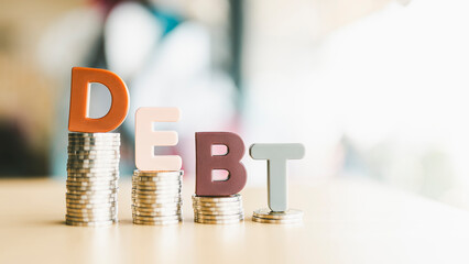 The letters of the word debt are placed on the table, the concept of the debt of the people,...