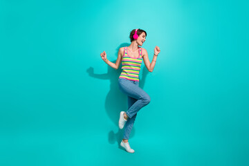 Fototapeta na wymiar Full body portrait of cheerful pretty lady good mood dancing listen favorite song isolated on turquoise color background
