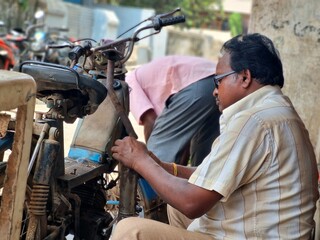 Mechanic repairing the old motorcycle 