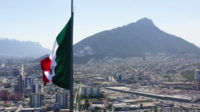 Aerial Panning Shot Of Flag At Mirador Del Obispado In City Near Mountains Against Sky - Monterrey, Mexico