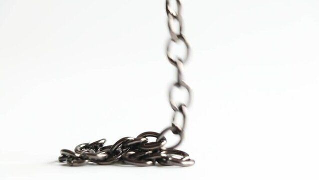 The chain goes down and lies in a pile on a white background