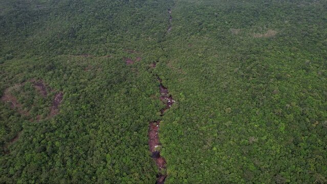 River and waterfalls flowing through a dense montain forest with green plants and trees Phu Quoc Vietnam Khu du lich sinh thai Suoi Da Ban