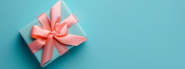 a blue box with a pink bow on it's side