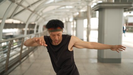 Smart handsome dancer moving hands while dance to hip hop music. Professional asian hipster wearing...
