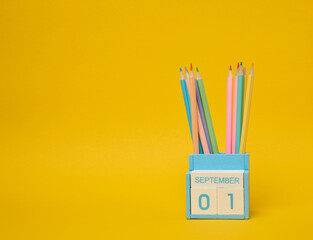 Multi-colored pencils and the date the first of September on the calendar.