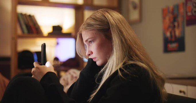 Mental health, mobile phone and woman with depression, sad and unhappy on sofa in living room, house and home. Anxiety, emotional and gen z girl with technology for contact, communication and comfort