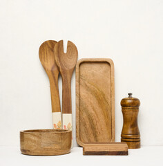 Various wooden kitchen utensils on a white background