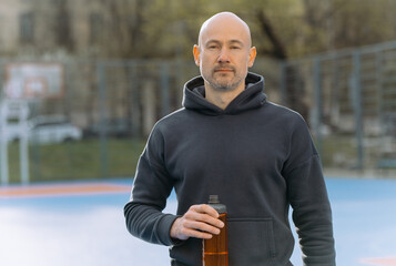 portrait of a bald athlete on the sports field after training