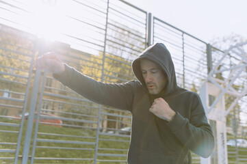 boxer training outdoors. shadow fight