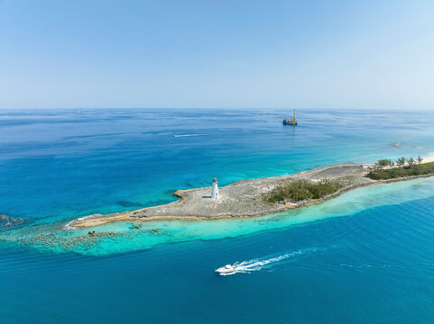 Aerial view of turquoise waters surrounding Nassau Harbour Lighthouse and Paradise Island, Nassau, The Bahamas.