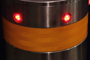 Modern lighting traffic bollard top closeup with lamps and reflection tape