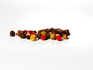 pepper, colorful grains, macro close-up photo, red, yellow, black grains, reflection in the base, photo from the front