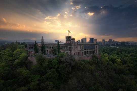 Aerial drone view of Castillo de Chapultepec, Bosque de Chapultepec park and city skyline in Mexico City at sunset, Mexico.