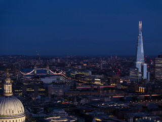 Aerial view of modern cityscape with Tower Bridge over Thames River, City of London, United Kingdom.
