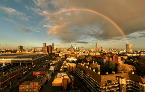 Aerial view of urban cityscape at sunset with rainbow over Waterloo, Lambeth, London, England.