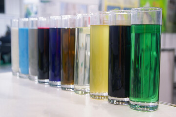 Multi-colored liquid in test tubes on a stand stand