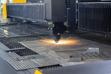 Laser cutting. Metal machining with sparks on CNC laser engraving maching