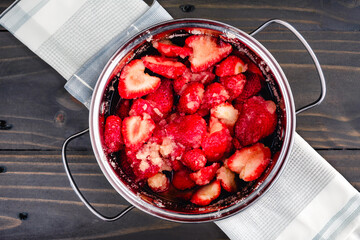 Macerated Strawberries in a Small Dutch Oven: Sliced strawberry halves after macerating with organic cane sugar in a cocotte