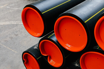 New polyethylene pipes. Water or gas pipe replacement. Reconstruction of the underground sewer system in city street. Modern pipeline for supplying heating to a residential area. Industrial concept