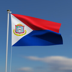 Sint Maarten Flag is waving in front of a blue sky with blurred clouds in the background