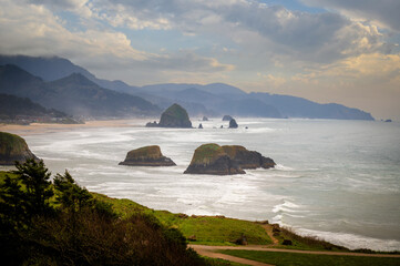 View of Haystack Rock from Ecola State Park. Known for some of the best views on the Oregon Coast and Haystack Rock, Ecola State Park is an ideal spot to watch enormous storm waves roll in.