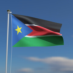 South Sudan Flag is waving in front of a blue sky with blurred clouds in the background