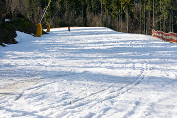 snowy slope for beginners illuminated by the sun. active holiday