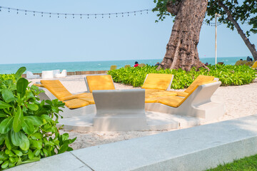Yellow Beach chairs and table in luxury resort hotel.