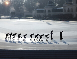 Silhouettes of ice skating people