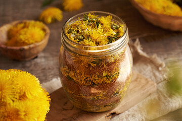 Preparation of dandelion syrup from fresh blossoms and cane sugar in a jar - 788716158
