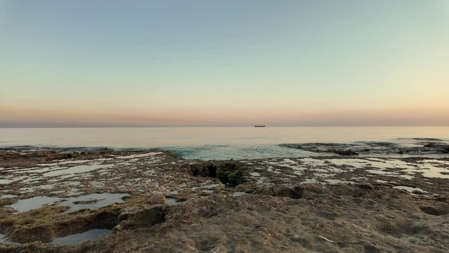 The Mediterranean Coast Against The Background Of Sunset In Slow Motion.