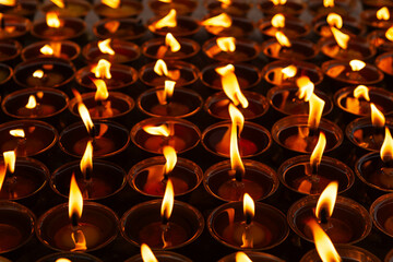 Many burning candles at night near Boudhanath in Kathmandu.